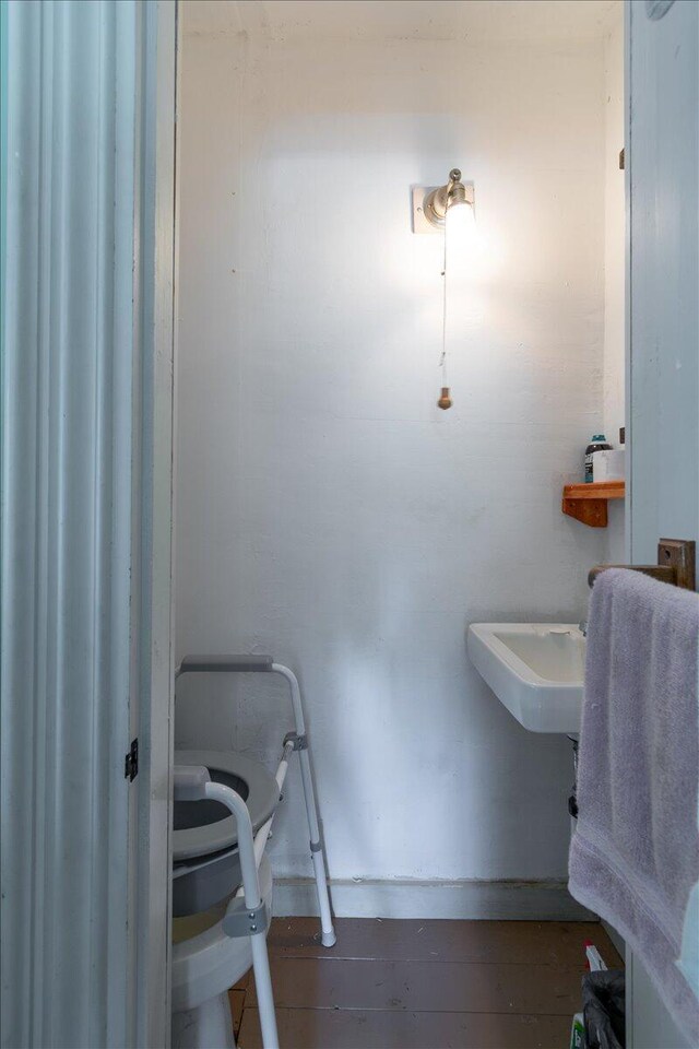 bathroom with hardwood / wood-style flooring