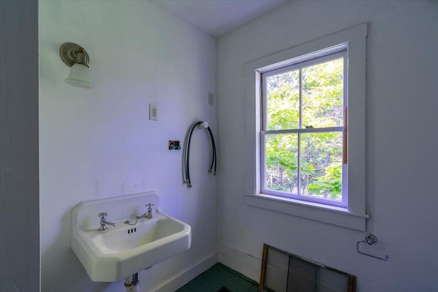 292300 Main Rd, Islesboro, ME 04848 - bathroom featuring a sink, baseboards, and a healthy amount of sunlight