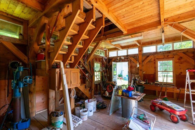 misc room featuring wood walls, wooden ceiling, and hardwood / wood-style flooring