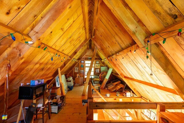 interior space featuring wood ceiling, light hardwood / wood-style flooring, and vaulted ceiling with beams