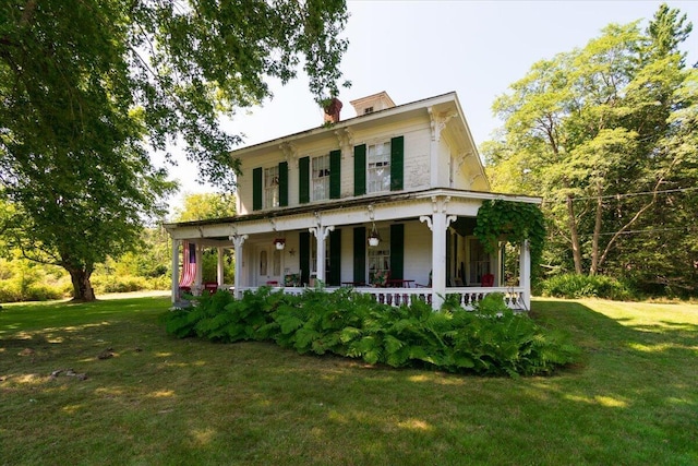 292300 Main Rd, Islesboro, ME 04848 - view of front of house with covered porch, a front yard, and a chimney