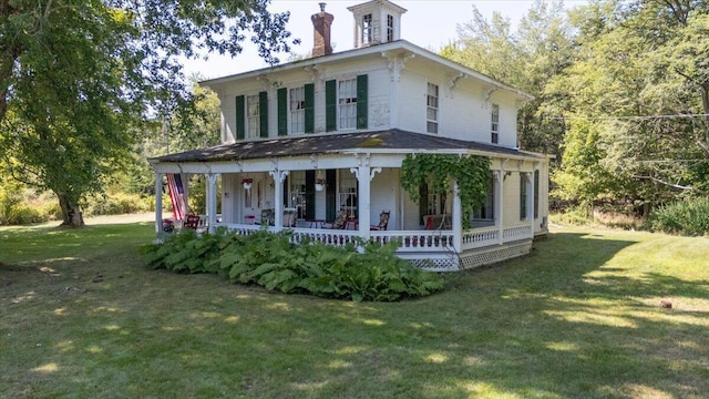 292300 Main Rd, Islesboro, ME 04848 - italianate-style house featuring covered porch, a chimney, and a front lawn