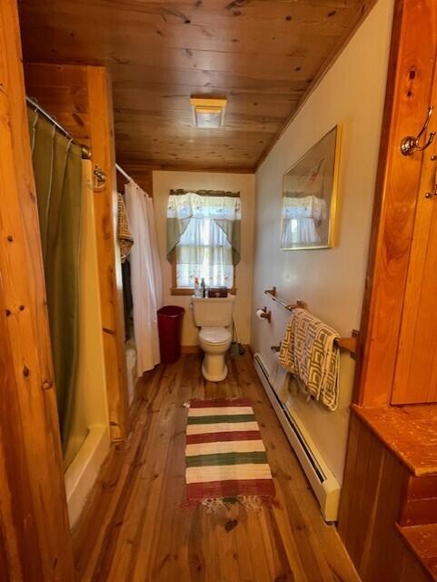 bathroom featuring wooden ceiling, toilet, wood-type flooring, and a baseboard radiator