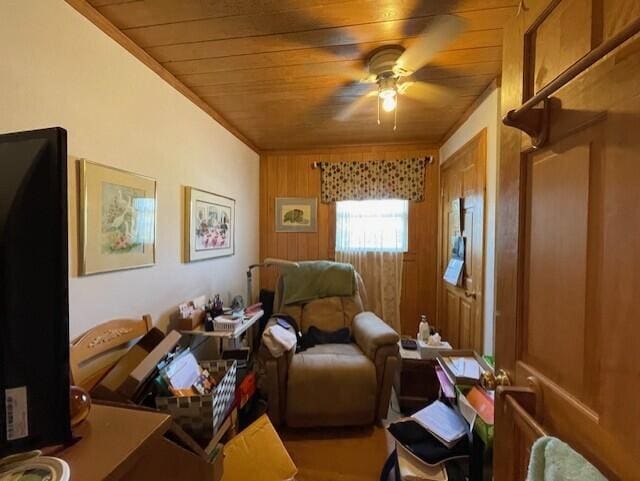 interior space with wood walls, ceiling fan, and wood ceiling