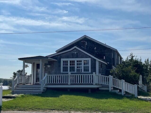 view of front facade with a front yard and a deck