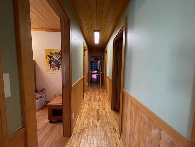 hallway with wood ceiling and light wood-type flooring