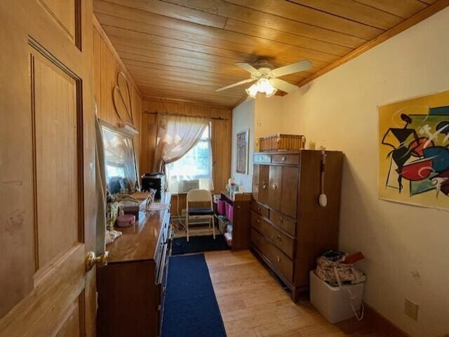 bedroom featuring light wood-type flooring, crown molding, wooden walls, and wooden ceiling