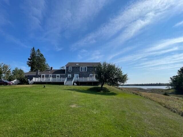 view of yard with a deck with water view