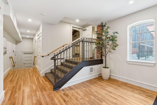 stairway featuring hardwood / wood-style floors