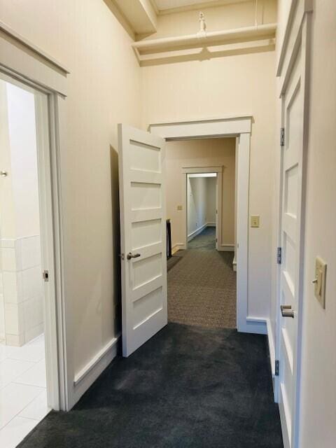 hallway with dark carpet