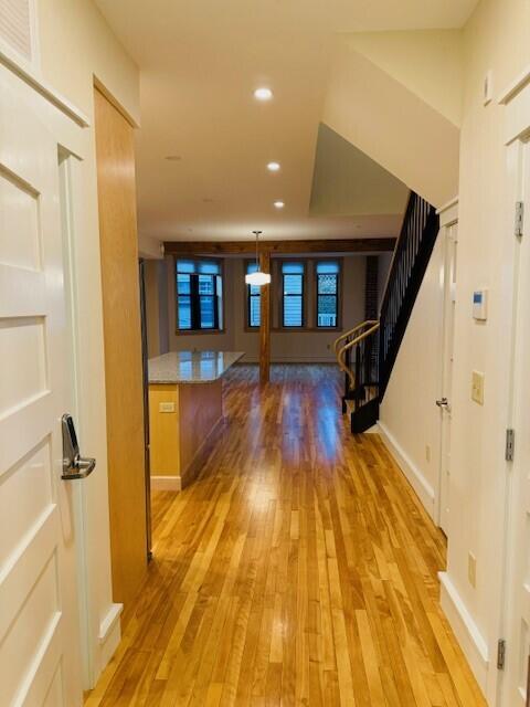 hallway with light hardwood / wood-style floors