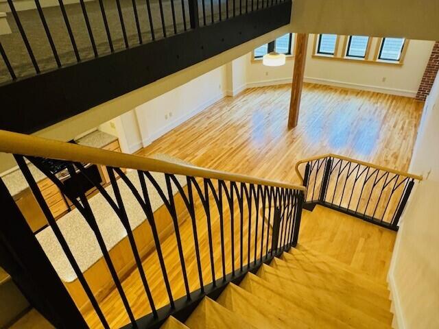 staircase with hardwood / wood-style floors