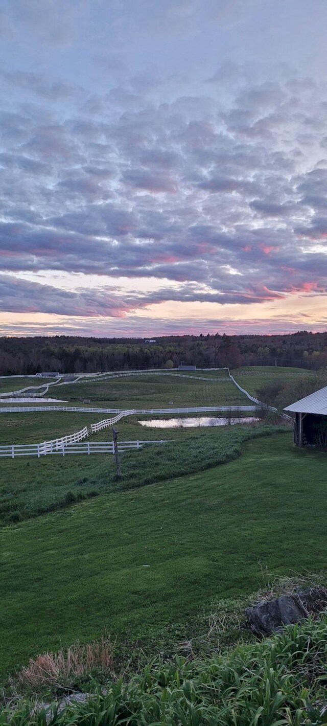 yard at dusk with a rural view