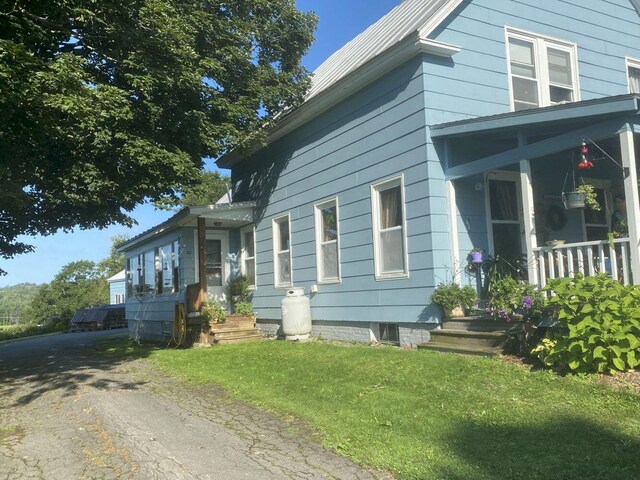 view of side of home featuring a yard