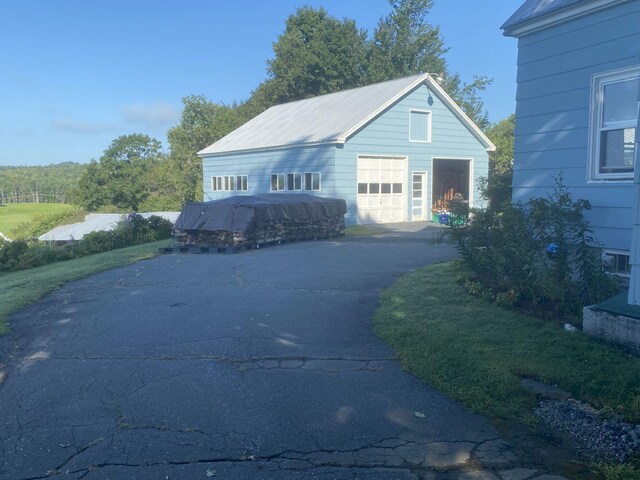 view of side of home featuring an outdoor structure and a garage