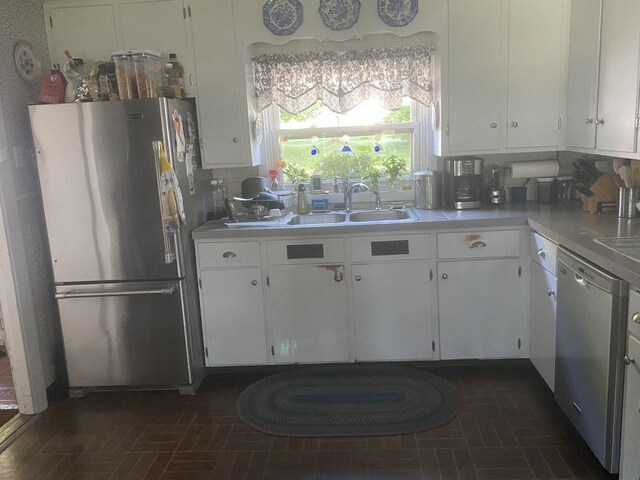 kitchen featuring stainless steel appliances, backsplash, and white cabinets