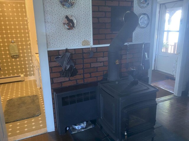 kitchen with radiator heating unit, a baseboard radiator, and a wood stove