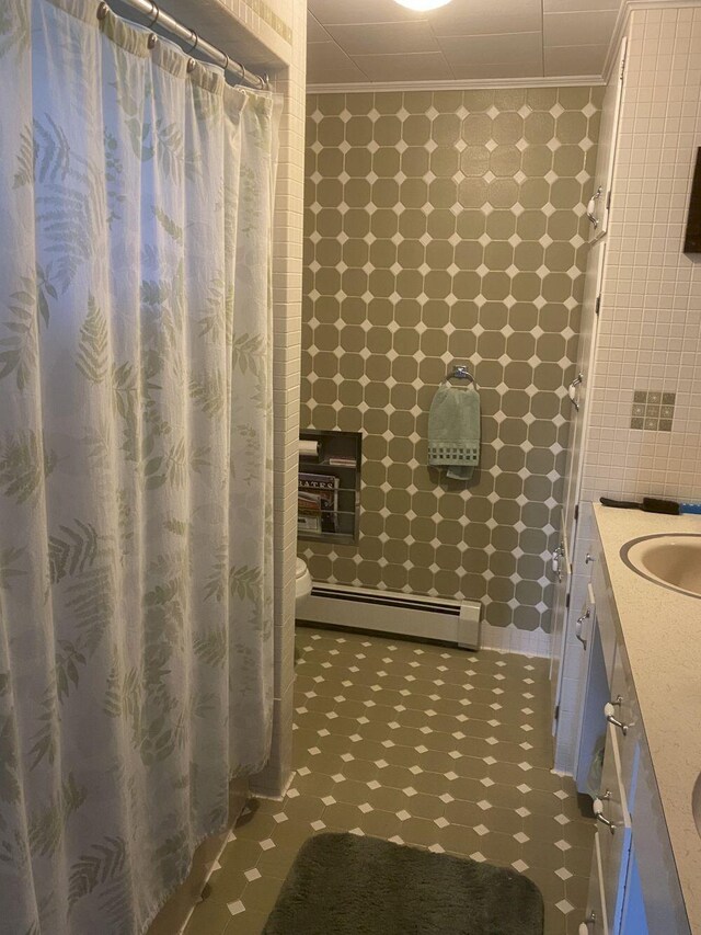 bathroom featuring vanity, tile patterned flooring, crown molding, a shower with curtain, and baseboard heating