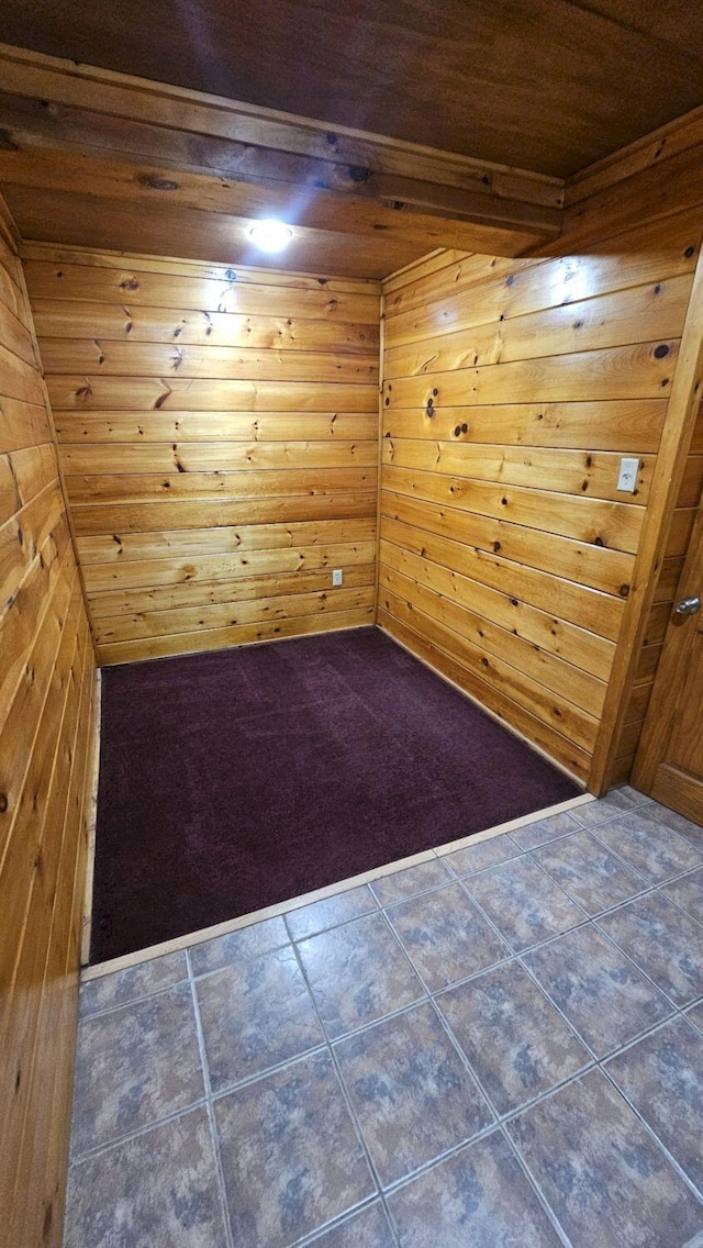 spare room featuring wood walls and wooden ceiling