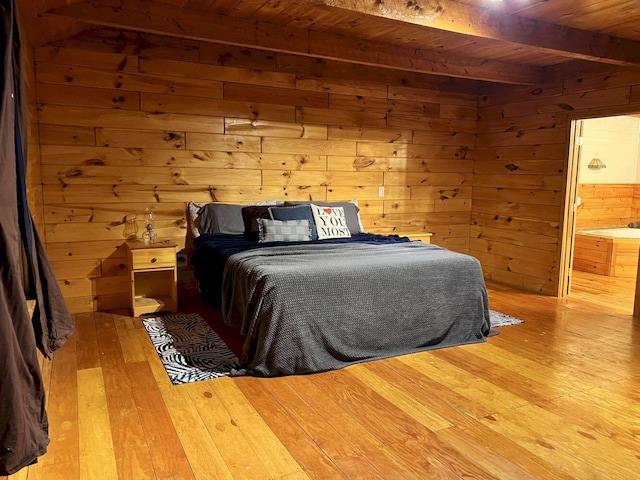 bedroom with wood walls, wood ceiling, light hardwood / wood-style floors, and beam ceiling