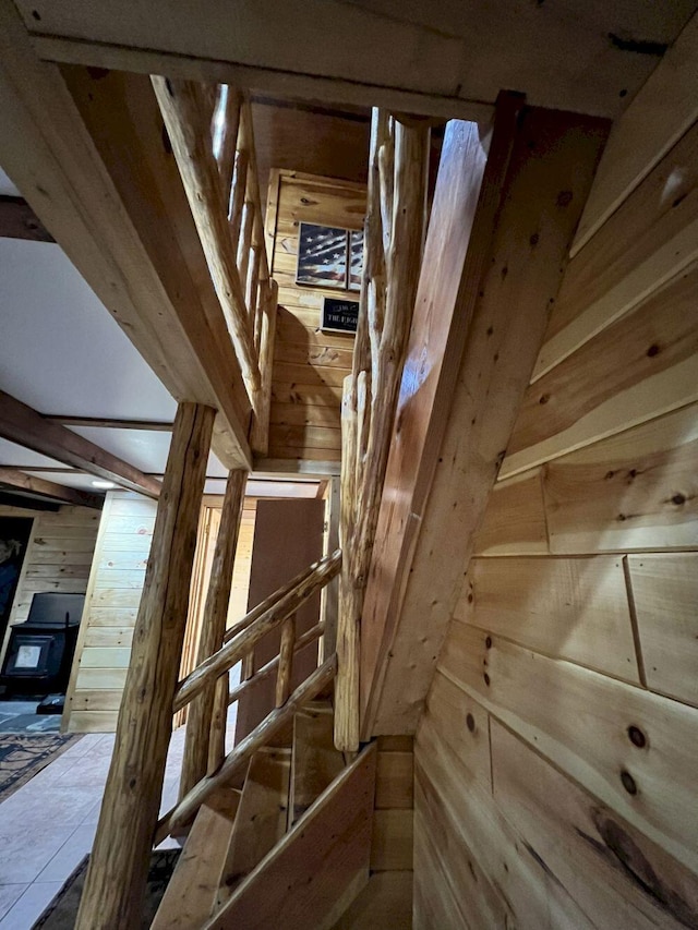 stairway featuring wooden walls