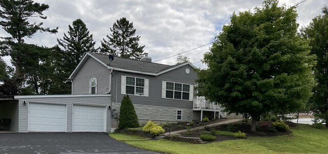 view of home's exterior featuring a garage and a lawn