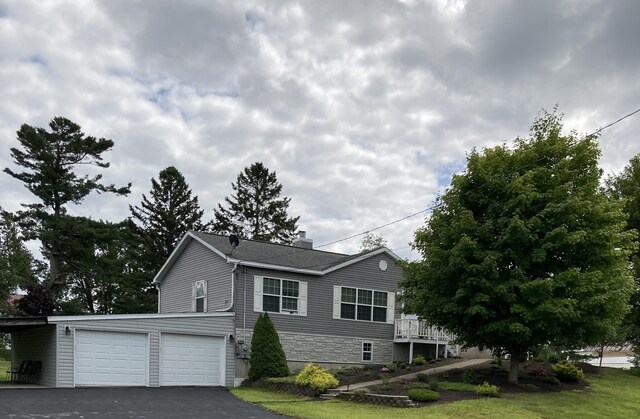 view of front of house with a garage and a front lawn