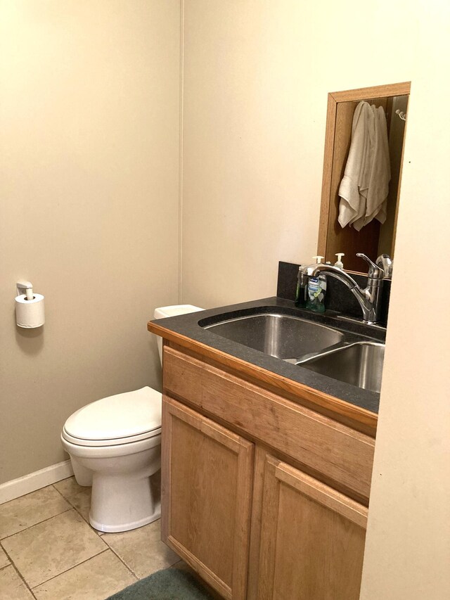 bathroom with vanity, tile patterned flooring, and toilet