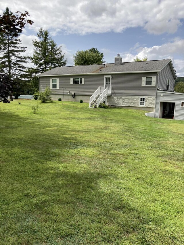 rear view of house featuring a lawn