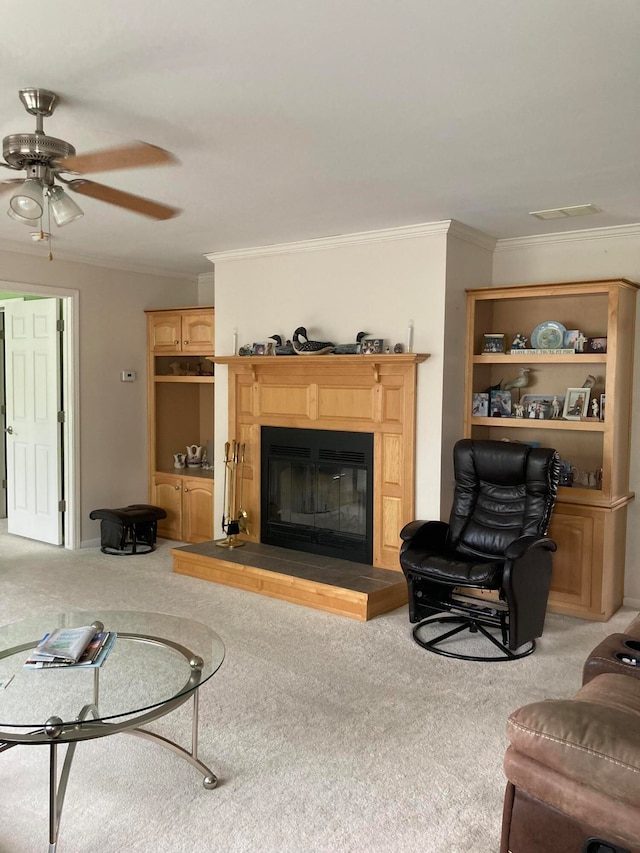 living room with ceiling fan, light colored carpet, and ornamental molding