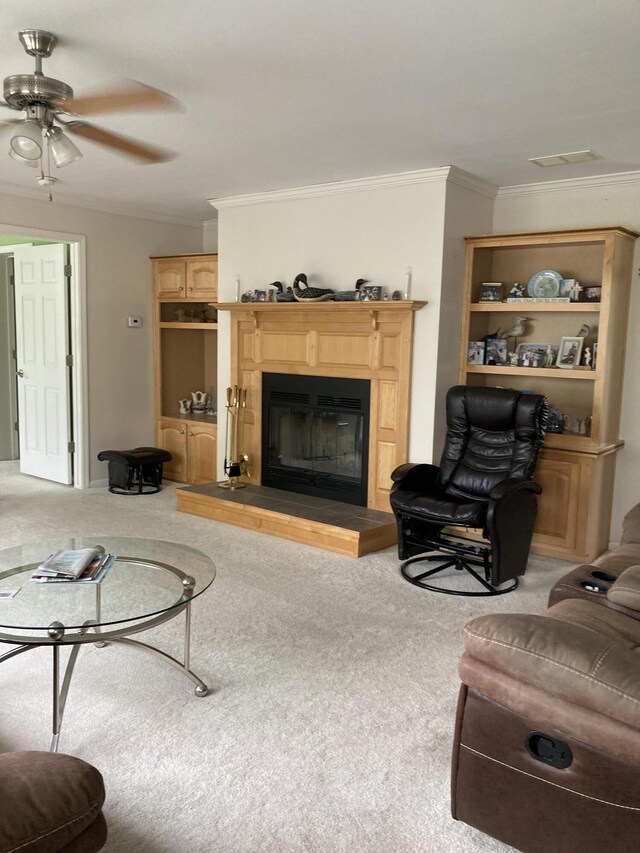 carpeted living room featuring ornamental molding and ceiling fan