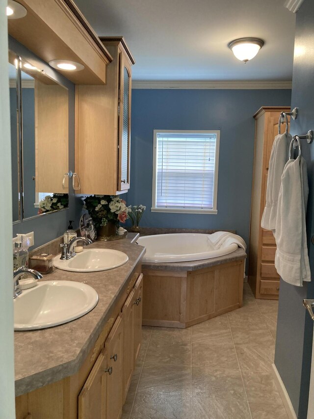 bathroom with tile patterned floors, ornamental molding, a bath, and vanity