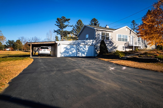 view of front of house featuring a carport and a garage