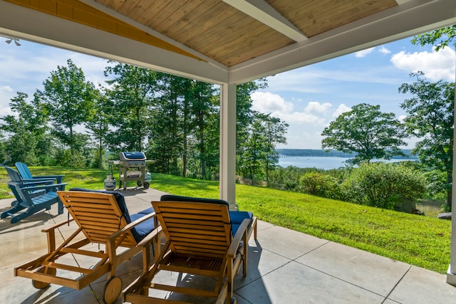 view of patio featuring area for grilling and a water view