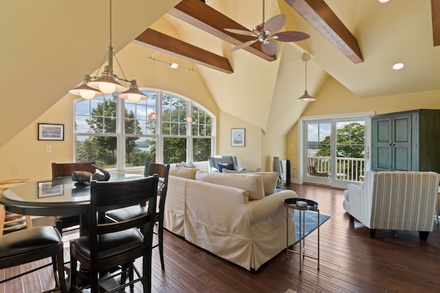 living room featuring plenty of natural light, beam ceiling, and dark wood-type flooring