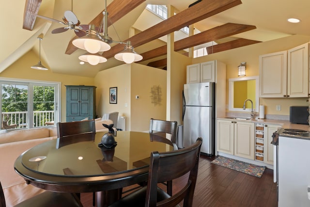 dining space with dark hardwood / wood-style flooring, vaulted ceiling with beams, and sink