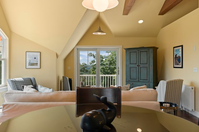 interior space featuring lofted ceiling with beams, hardwood / wood-style flooring, and radiator