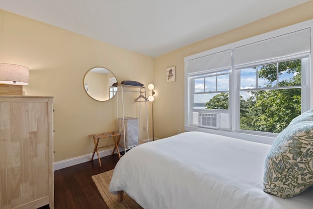 bedroom with dark hardwood / wood-style flooring and cooling unit