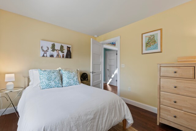 bedroom with dark hardwood / wood-style floors