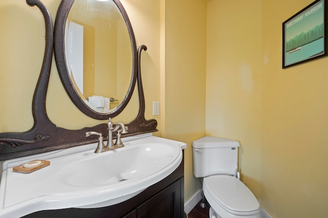 bathroom featuring vanity and toilet