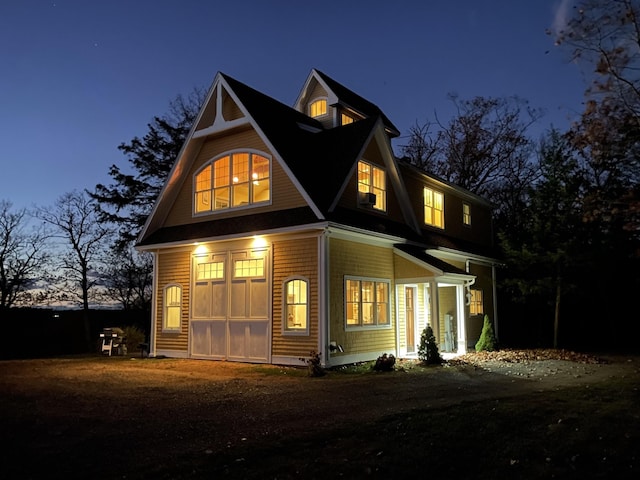 view of back house at dusk