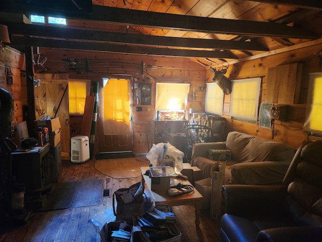 living room with beamed ceiling, hardwood / wood-style floors, and wood walls