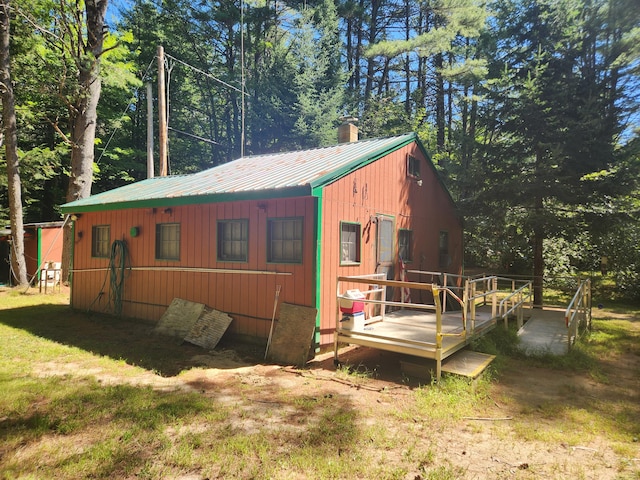 view of property exterior featuring a wooden deck