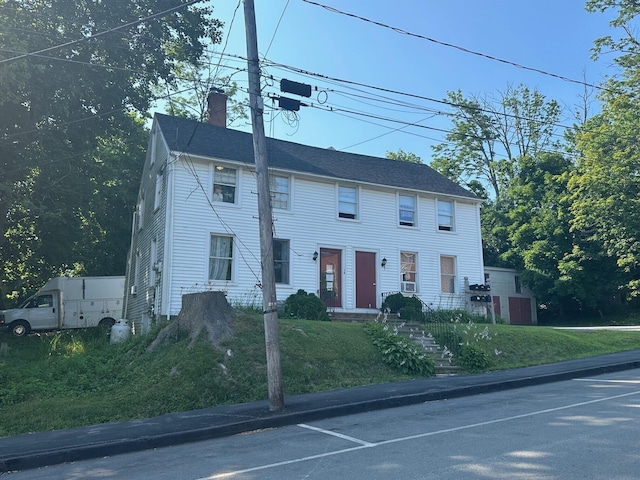 colonial-style house with a chimney