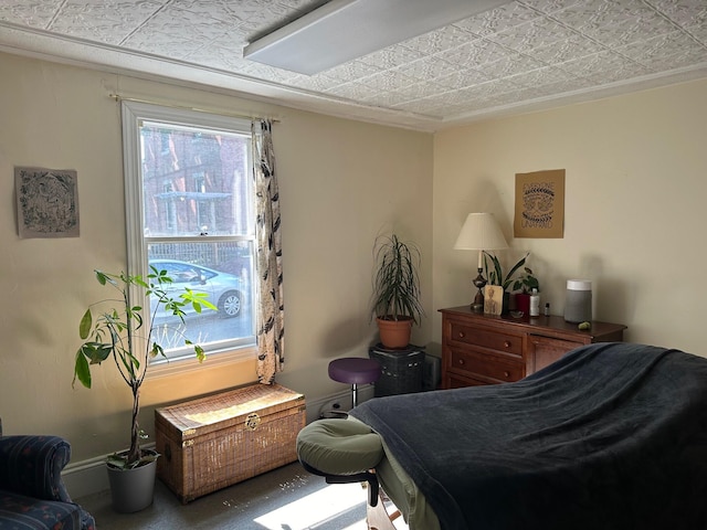 bedroom featuring an ornate ceiling and baseboards