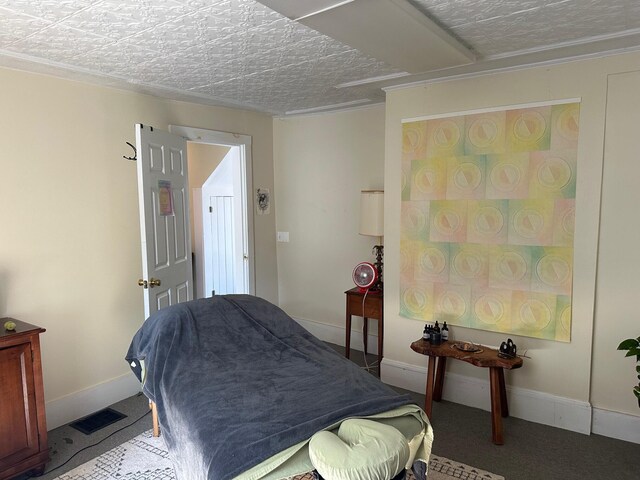 carpeted bedroom featuring a textured ceiling