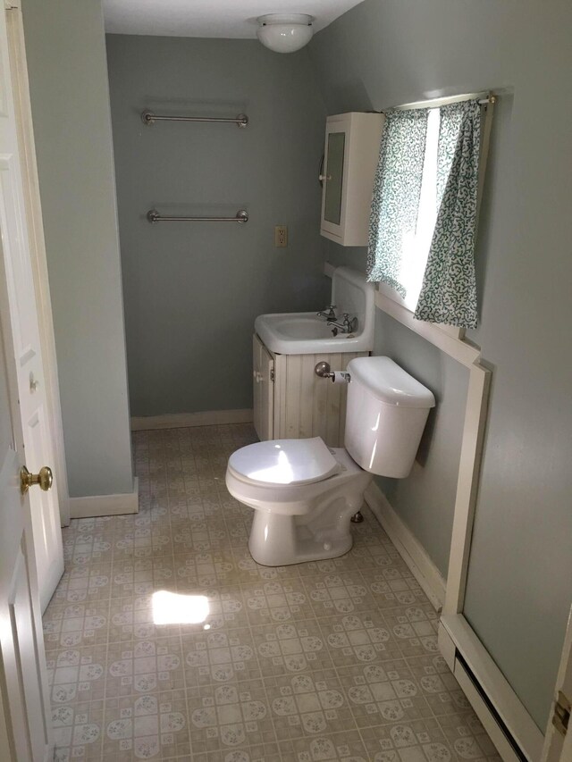 bathroom featuring vanity, toilet, walk in shower, and tile patterned flooring