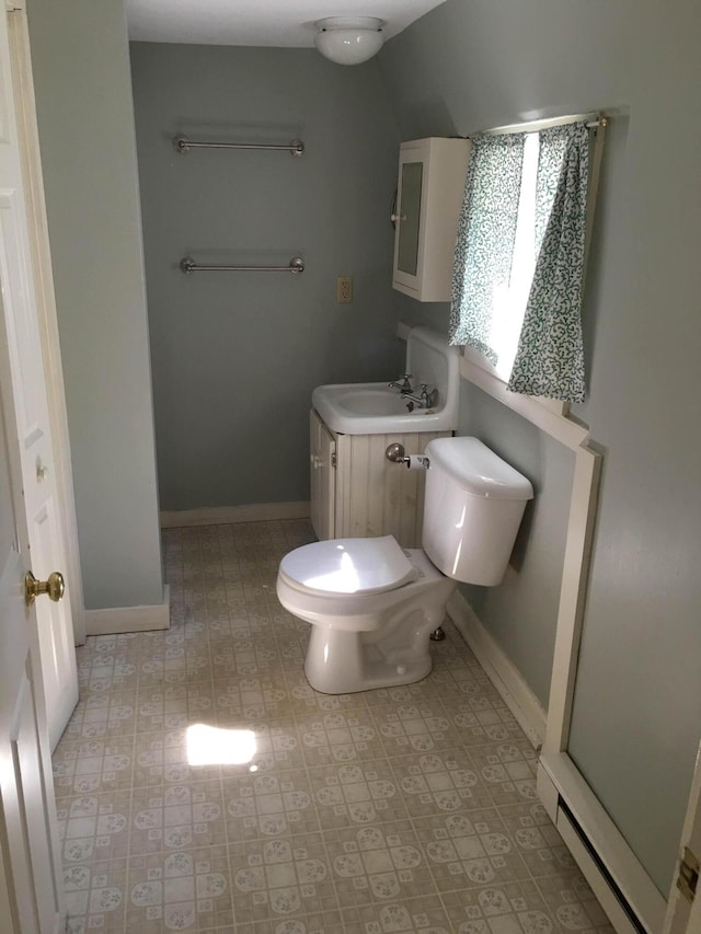 bathroom featuring baseboards, toilet, vanity, and baseboard heating