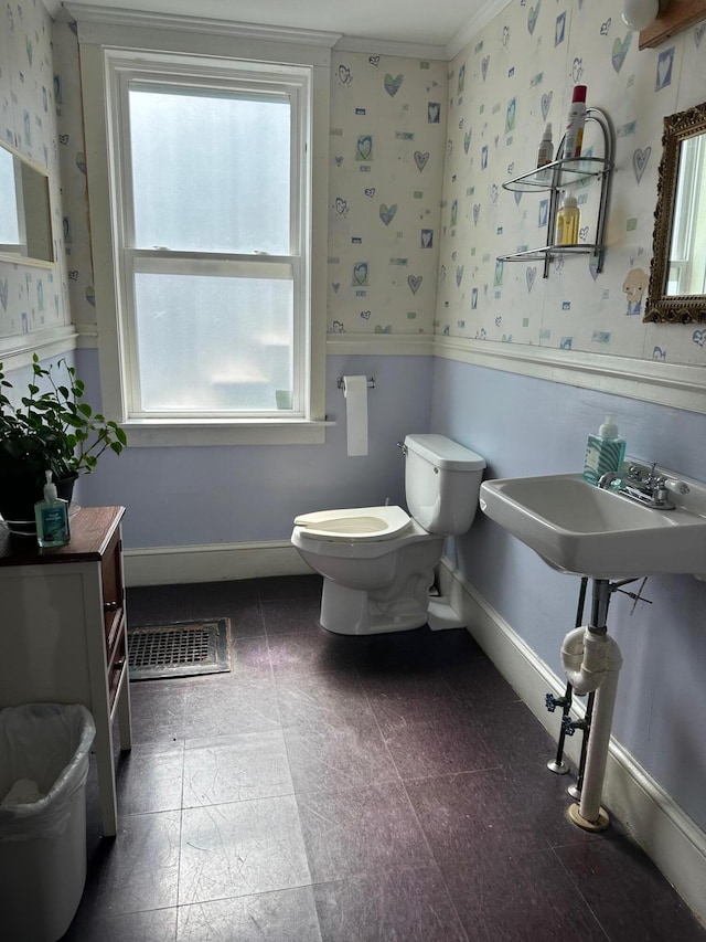 bathroom featuring baseboards, visible vents, toilet, and wallpapered walls