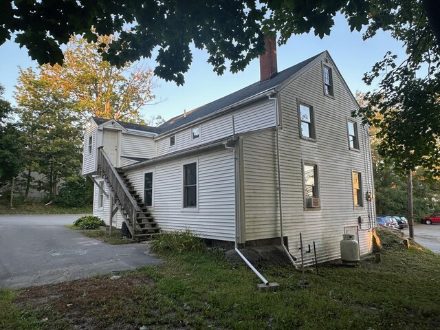 view of side of home with a yard